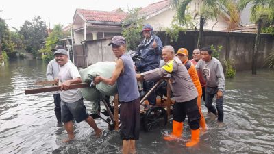 Bhabinkamtibmas Joglo  Giat Gotong Royong Bersama Warga Bantu Warga Melintas Area Banjir